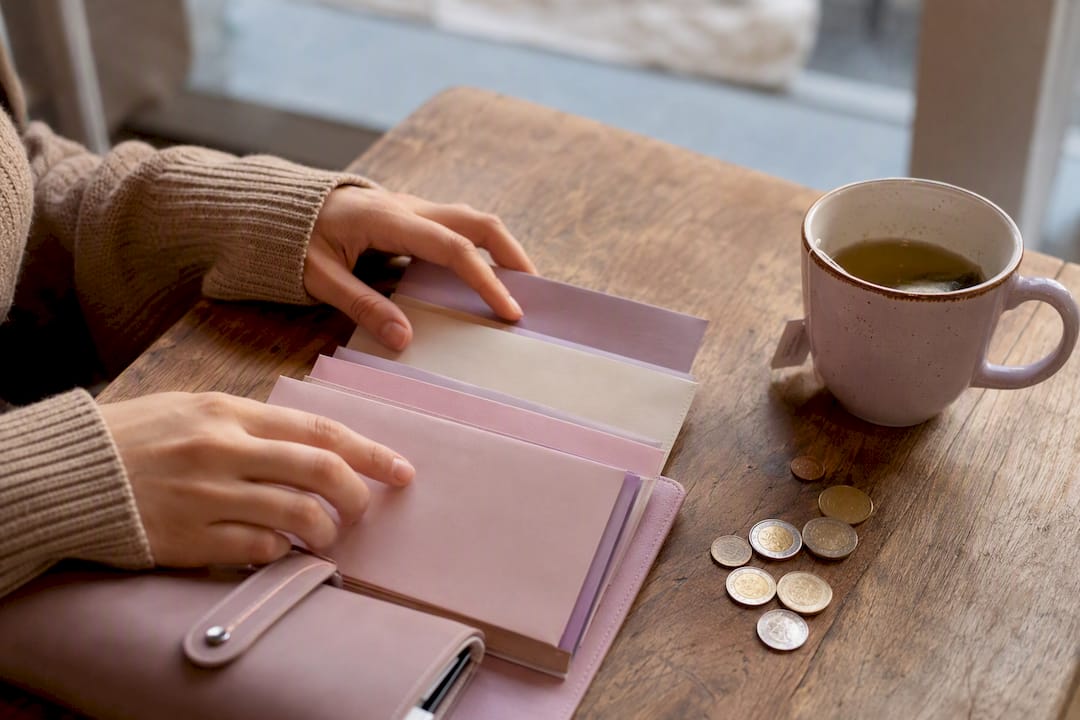 Hands closing zipper cash envelope